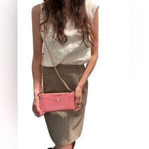 Chanel Pink Clutch with Iconic Logo and Minimalist Design